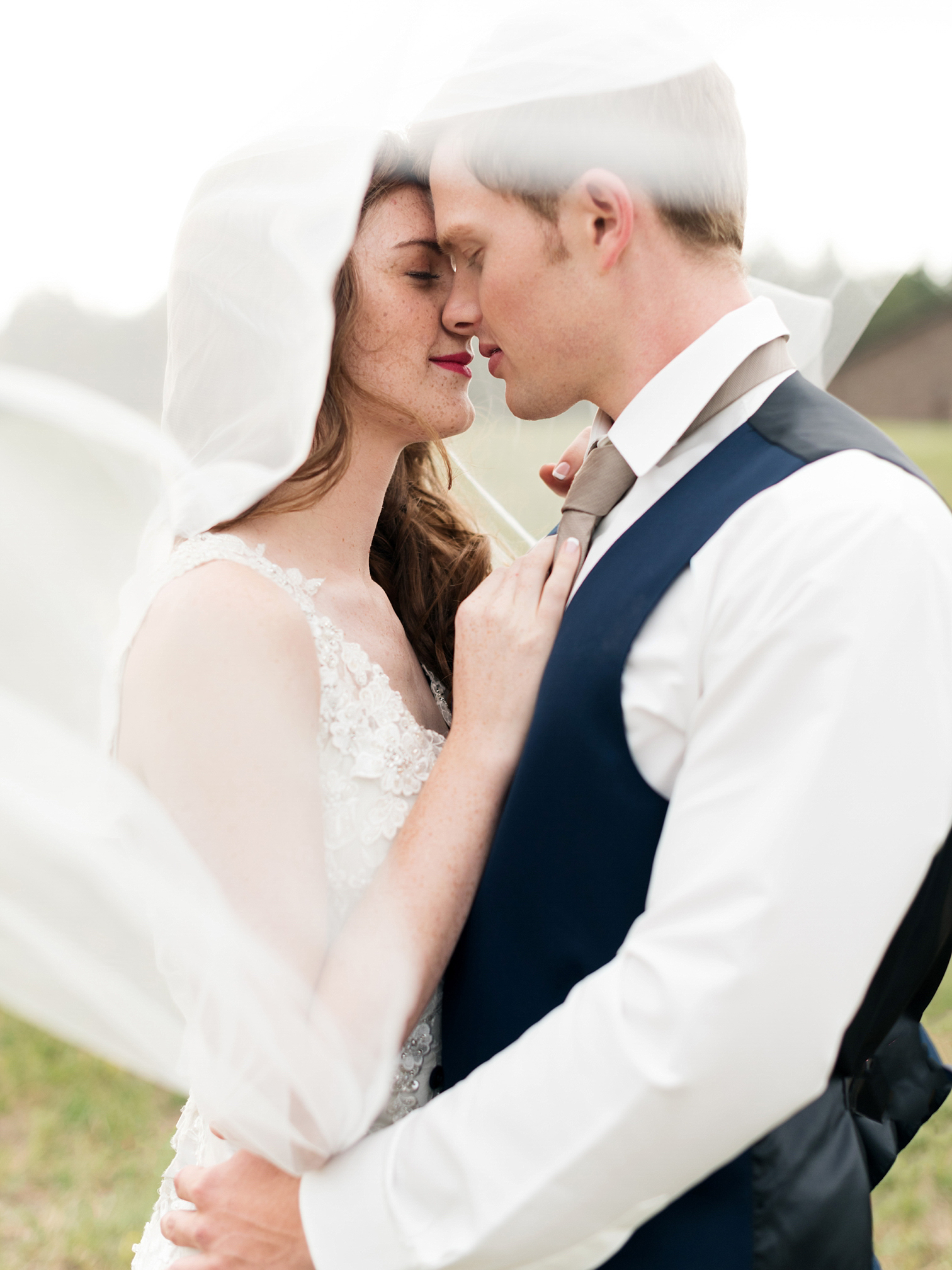 Married Couple Kissing Under Veil, Colorado Weddings, Danielle DeFiore Photographer